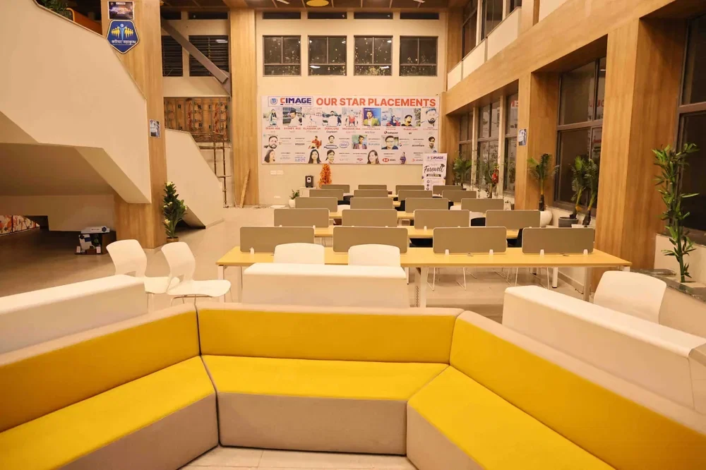 Upholstered banquette seating in the atrium, with shared tables behind