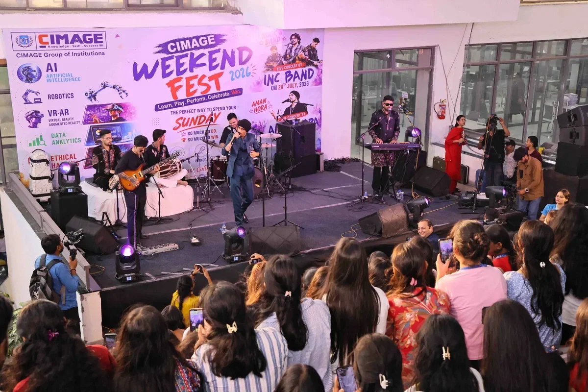 A live band on stage at CIMAGE Weekend Fest, playing to a packed floor